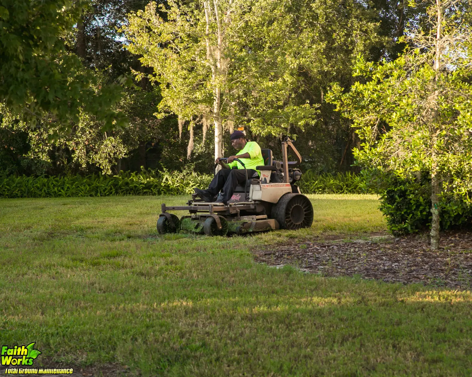 Faithworks grounds maintenance equipment and crew serving a managed property
