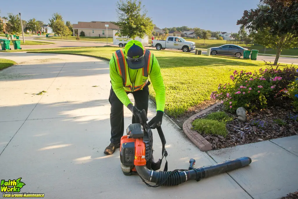 Lawn care profession blowing a residential lawn in Central Florida