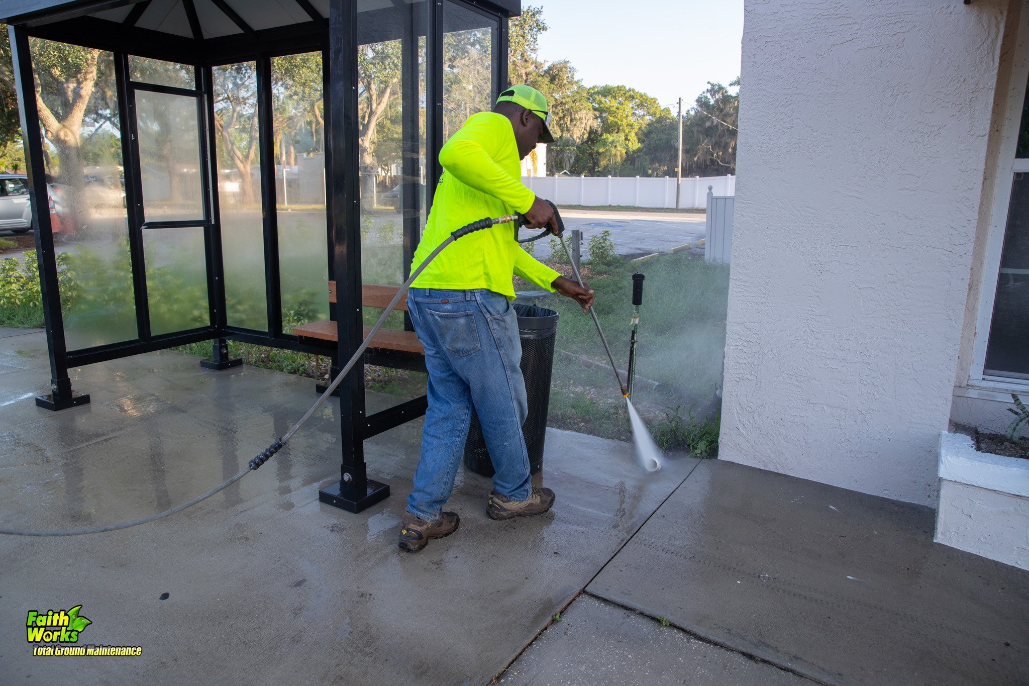 Faithworks technician with pressure washing wand