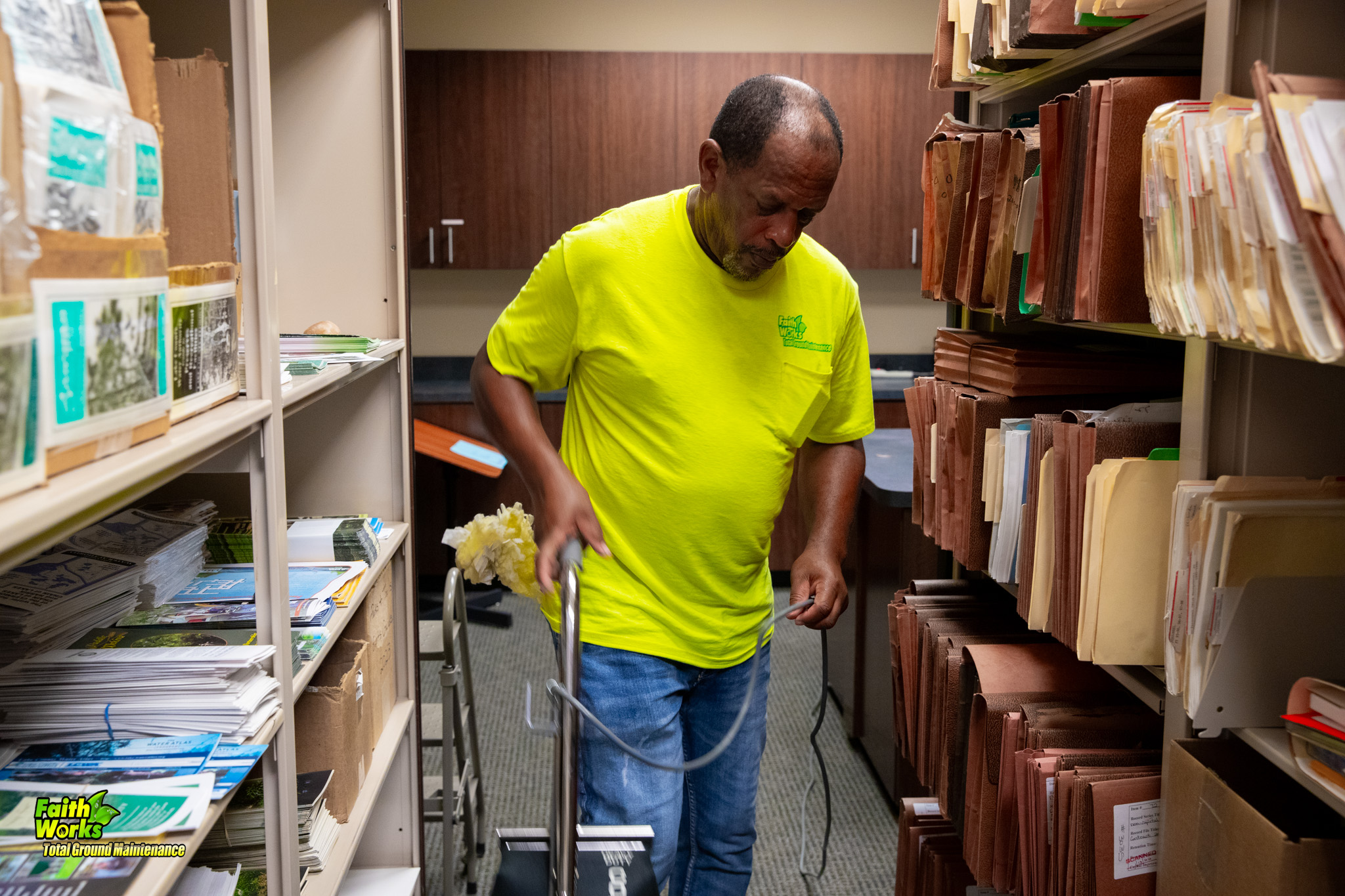 Faithworks team member vacuuming a commercial office